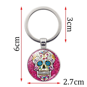 Sugar skull glass keychain with pink glitter background and detailed dimension markers