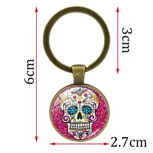 Sugar skull keychain with bronze finish and pink glitter glass pendant for Dia de los Muertos