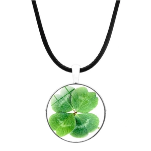 Detailed view of silver clover pendant with green leaf specimen and black leather cord