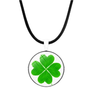 Detailed view of lucky green four-leaf clover pendant with round glass on black cord