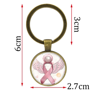 Porte-clés ailes d'ange ruban rose avec anneau en bronze et pendentif dôme en verre