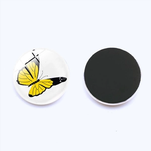 Detailed view of 25mm round glass magnet showing front butterfly design and back magnetic base