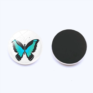 Detailed view of circular butterfly glass magnets showing both front and magnetic back