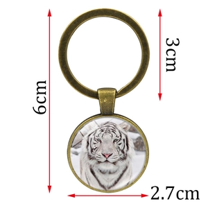 White tiger photo keychain in bronze alloy frame with size details 6cm overall length