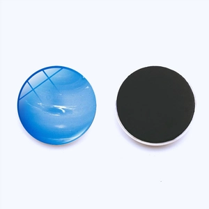 Detail of round planet fridge magnet showing glass texture and black magnetic backing