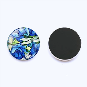 Detailed view of 25mm glass dome fridge magnet with blue floral and dragonfly pattern
