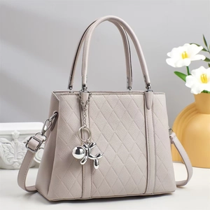 Chic quilted beige tote bag with silver balloon dog charm and removable shoulder strap