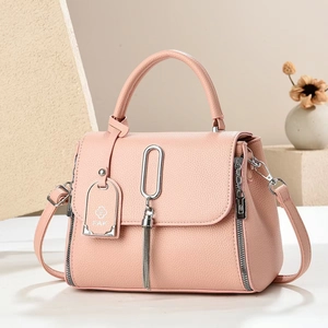 Pink litchi grain leather handbag with silver tassel and adjustable shoulder strap
