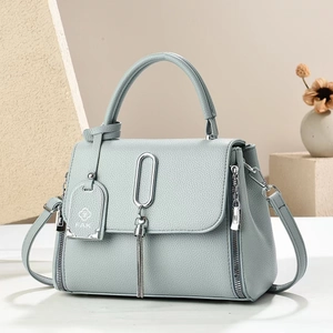 Chic blue-gray crossbody handbag with lychee pattern leather and tassel detail