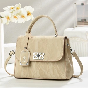 Beige textured leather handbag with silver clasp and floral background for women