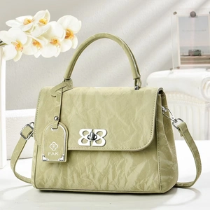 Retro light green textured leather handbag with silver twist lock and shoulder strap