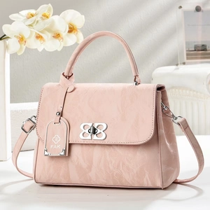 Vintage pink crossbody handbag with silver bow lock and marble texture on grey background