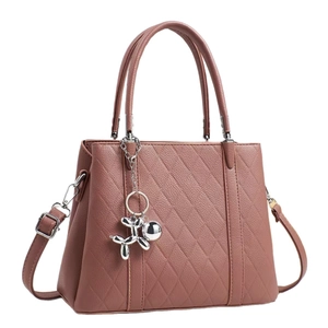 Dusty pink quilted crossbody tote bag with top handles and silver balloon dog charm
