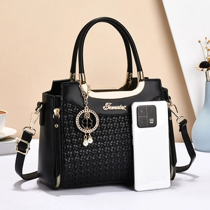 Elegant black woven leather handbag with gold metal handle and adjustable shoulder strap