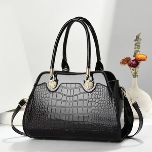 Elegant black crocodile embossed tote bag with gold hardware and removable strap