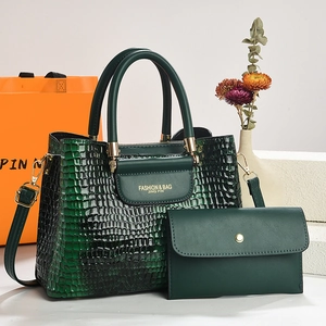 Dark green crocodile pattern handbag with matching wallet and golden hardware
