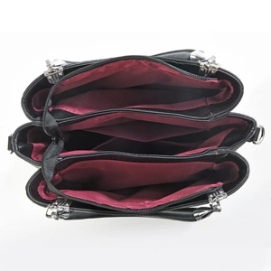 Interior view of black leather tote bag with three compartments and burgundy fabric lining