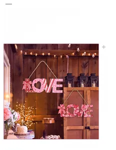 Detail of wooden LOVE signs with red roses and pink polka dots for Valentine decor