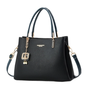 Fashionable black lychee leather handbag with blue handles and gold chain decoration