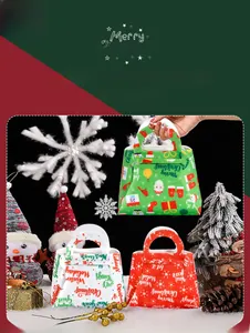 Close-up of three festive felt Christmas gift bags with classic holiday motifs and handles