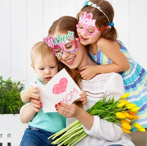 Close-up of mother and children wearing floral Mother's Day paper party glasses