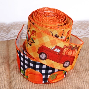 Close-up of autumn pumpkin truck ribbon with wire edges on vintage burlap background