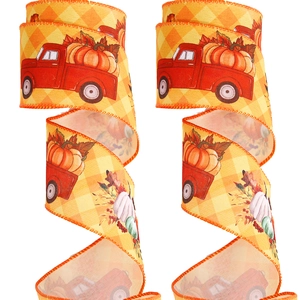 Detail of harvest ribbons featuring red pumpkin trucks on yellow plaid fabric texture