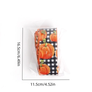 Detail showing pumpkin and plaid patterns on burlap ribbon rolls in plastic packaging