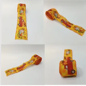 Detail view of 6.5cm faux linen wired ribbon with autumn pumpkin and truck print pattern