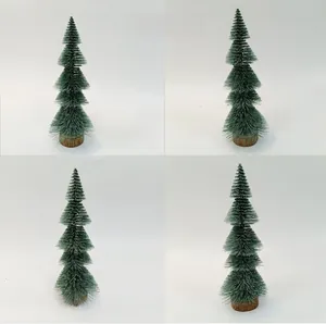 Mini artificial pine Christmas tree with snowy needles and natural wood base detail