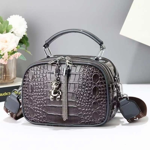 Textured crocodile pattern crossbody bag in dark taupe with bear charm and wide strap