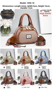 Detailed view of colorblock crossbody bag with floral strap and plush charm detail