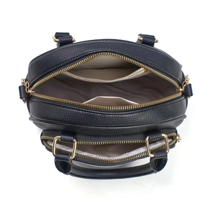 Top view of black pebbled leather handbag showing dual golden zippers and spacious interior