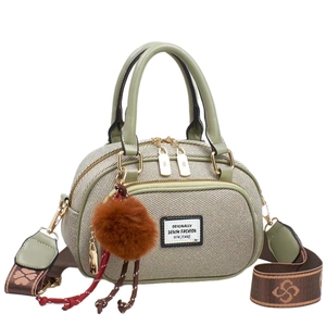 Retro Boston handbag with woven green panels and a brown jacquard wide shoulder strap