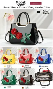 Detail view of glossy handbag featuring red rose ornaments and detachable strap