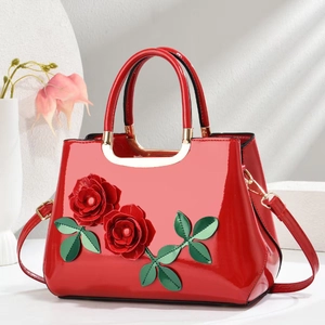 Glossy red patent leather handbag with 3D floral accents and gold metal hardware for women