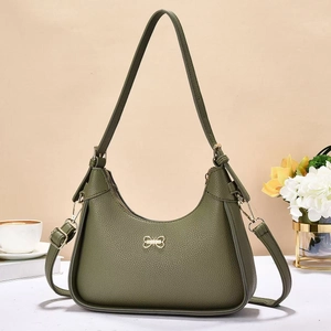 Vintage green hobo bag with litchi grain texture and golden butterfly logo on beige background