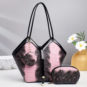 Three-piece women's tote set in pink snakeskin pattern with matching purse and small pouch