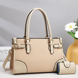 Detail of beige tote bag with woven texture, metal buckles and matching card holder