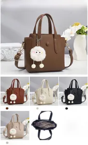 Detail view of lychee texture tote bag with plush charm and interior structure display