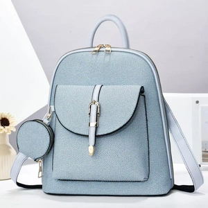 Detail of light blue backpack with gold metal buckles and a matching detachable round coin purse