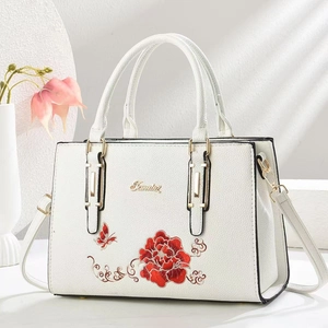Weiße Henkeltasche aus genarbtem Leder mit Blumenstickerei und Golddetails