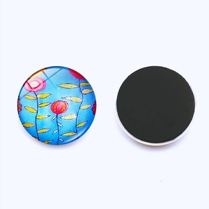 Detail view of 25mm Tree of Life glass fridge magnet with floral pattern and magnetic back