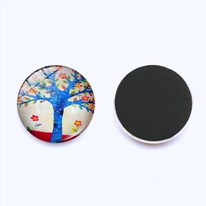 Detail view showing front Tree of Life art and back magnetic base of the glass fridge magnet