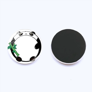 Close-up of circular glass panda fridge magnet with cute bamboo illustration and black magnetic back
