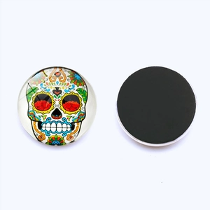 Detailed view of Mexican sugar skull glass magnets showing front pattern and magnetic back