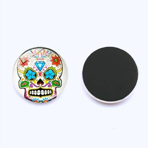 Dual view of sugar skull glass fridge magnet with colorful pattern and black magnetic back