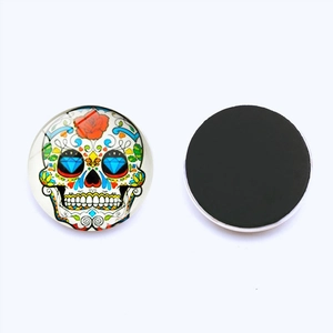 Detailed view of 25mm round sugar skull glass fridge magnet with magnetic back