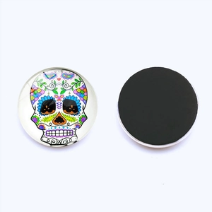 Close-up of circular Day of the Dead sugar skull fridge magnet with magnetic back
