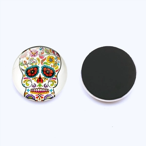 Detail showing front sugar skull glass design and flat magnetic back of the round fridge magnet